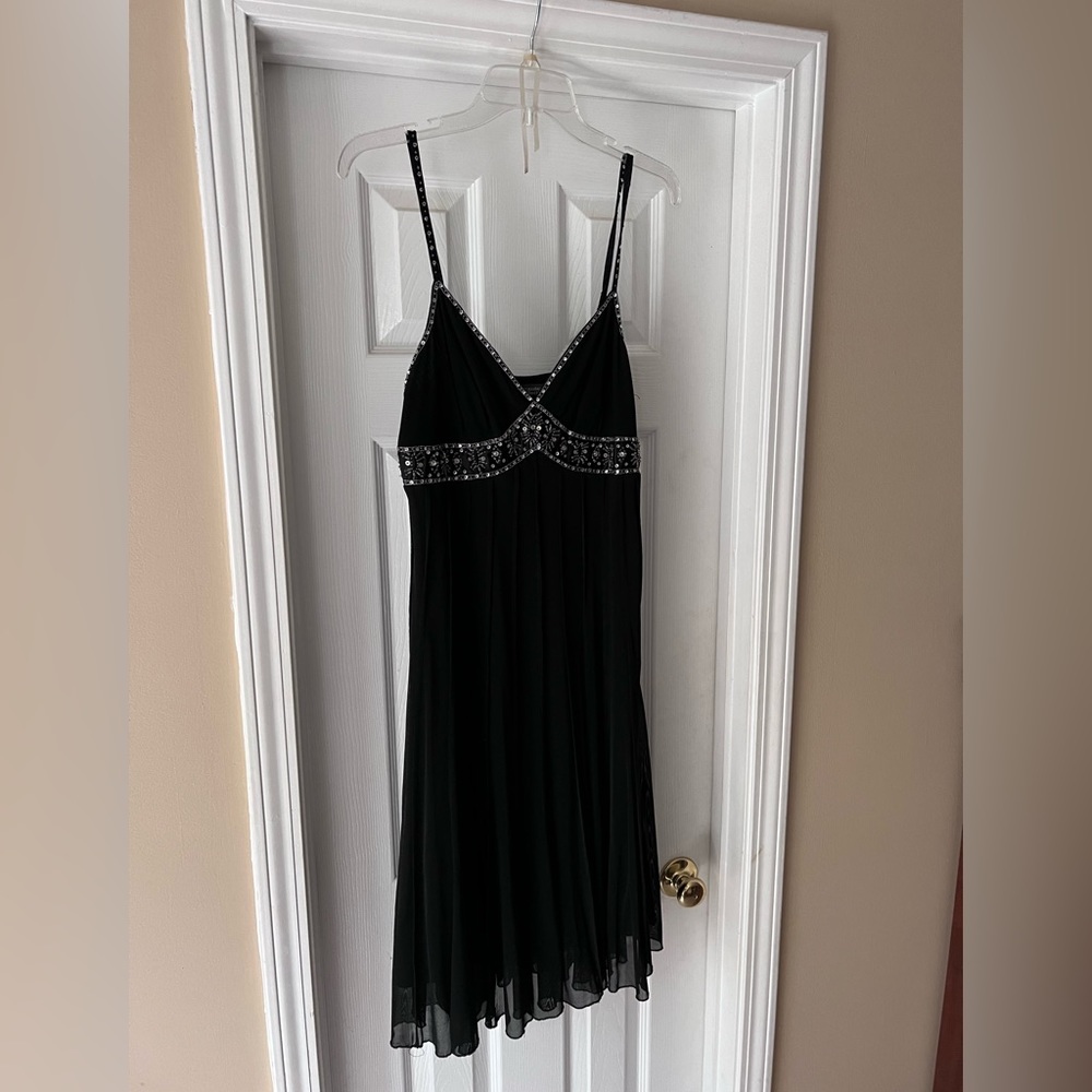Dress barn black dress with rhinestone bust design.